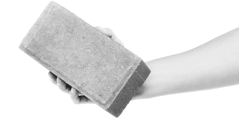 A hand holding a house brick, representing local SEO foundations built right