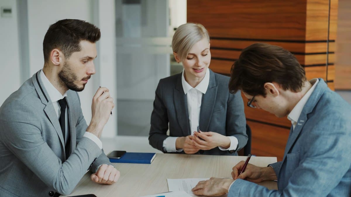 Solicitors reviewing a client agreement in a London law firm meeting room