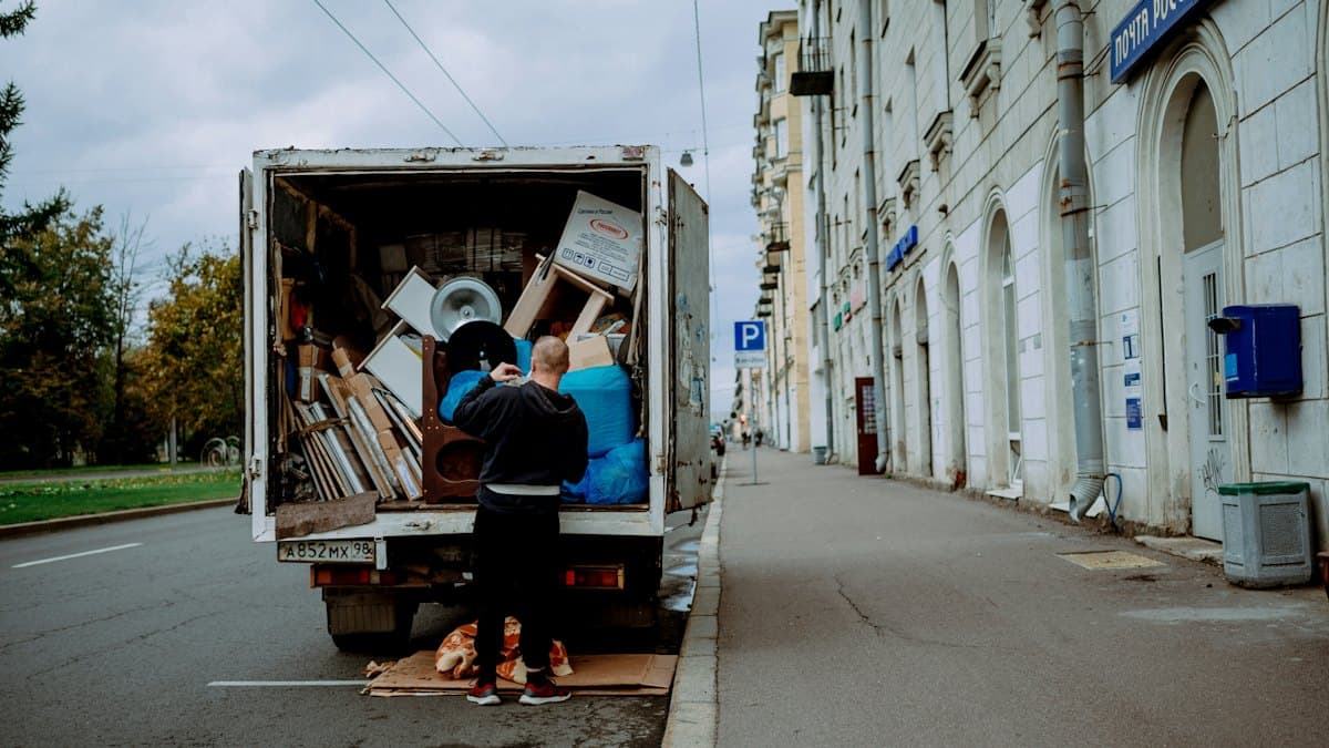 A removals crew unloading furniture from a moving van in London
