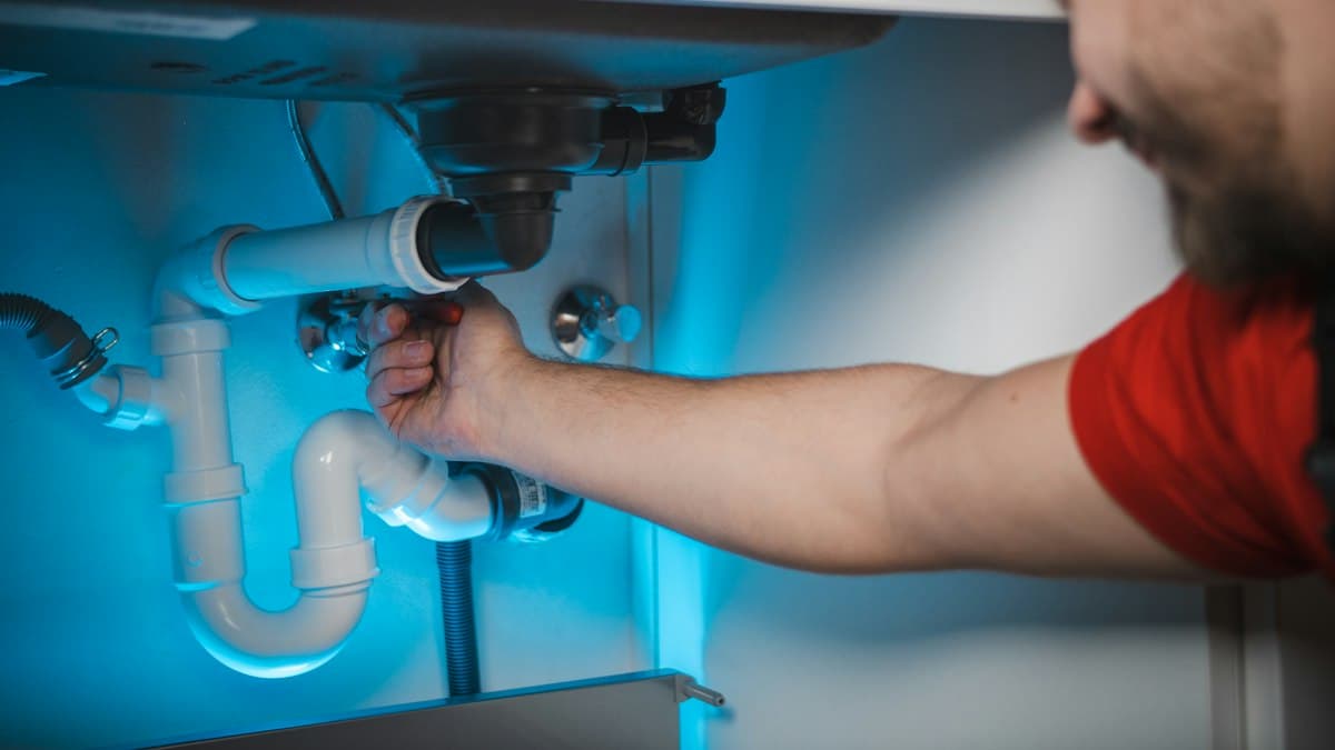 A plumber fitting pipework on a London job, the trade this SEO campaign is built for